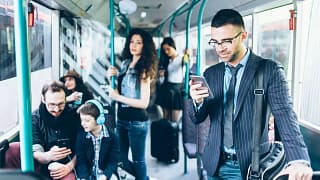 People on a bus with several using their cell.width EBrObLs.jpg