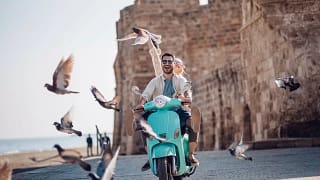 Tourists riding motorized scooter in old euro.width DbAtPjZ.jpg