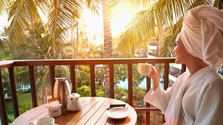 Woman in robe drinking coffee on balcony at t.width XIPpxO.jpg