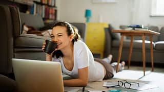 Woman pauses paying bills to enjoy coffee k.width .jpg