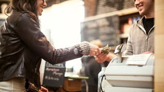 Woman paying for purchase with cash. VMjwvr.width .jpg