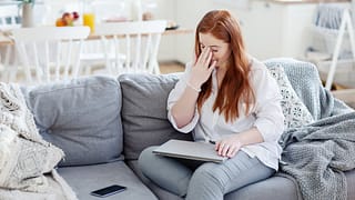 Woman rubbing the bridge of her nose appearin.width UGzXRBl.jpg