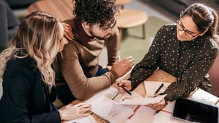 Young couple going over paperwork with female.width hAKGlR.jpg