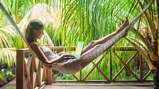 digital nomad using a laptop in a hammock sur.width XuhacNK.jpg