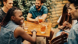 friends drinking beers at patio table WwKdweZ.width .jpg