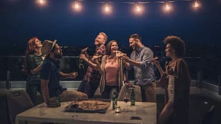 friends eating pizza and beer at rooftop part.width pMowu.jpg