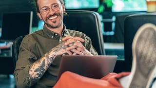 getty happy feet on desk smiling tattoos.jpg