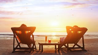 mature couple relaxing on beach at sunset.jpeg