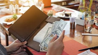 paying restaurant check with cash.width .jpg