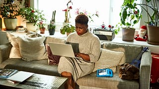 person on couch on laptop uUczik.width .jpg