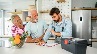 repairman talks to couple in kitchen KLkHSy.width .jpg