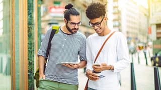 two men outside with phone and credit card Fh.width .jpg
