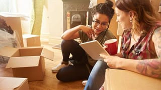 two women with moving boxes and tablet IrIKZ.width .jpg