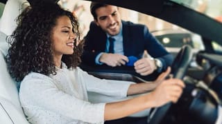 woman in car with salesman Geqvxx.width .jpg