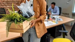 woman leaving office with box oXLGUKN uxkHRi.width .jpg