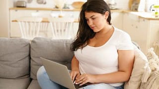 woman on couch with laptop.width .jpg