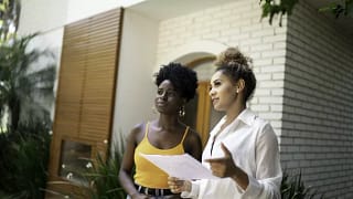 woman with realtor outside house.width .jpg