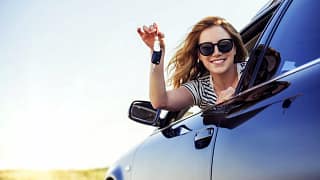 young woman leaning out of car window and hol.width maFaPm.jpg