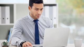 younger man at laptop serious gettyimages .jpg