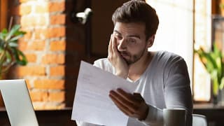 StressedOutGuyLookingAtPaper.width .jpg