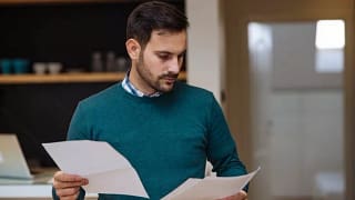 man holding papers zXjSvlk.width .jpg