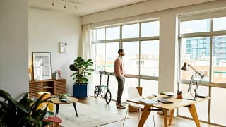 person looking out apartment window PwKvtj.width .jpg