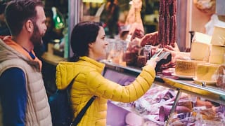 Couple using credit card at farmers market Rc.width .jpg