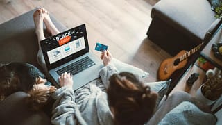 Woman black friday shopping from her couch at.width vuMiEiu.jpg