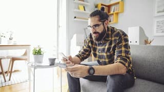 man holding phone and credit card GXOd.width .jpg