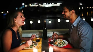 young man and woman sitting at table eating d.width xnzmD.jpg