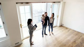 family viewing new house with realtor.width .jpg