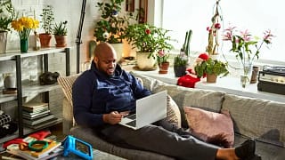 man on couch with laptop and credit card wnWu.width .jpg