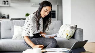 woman on couch with papers and tablet hBtEvpP.width .jpg