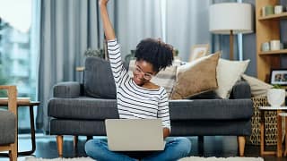 woman on laptop celebrating rLixvEH.width .jpg