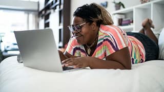 person on bed with laptop Hpu.width .jpg