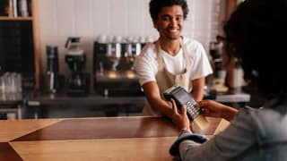 woman paying cafe cashier with credit card.width .jpg