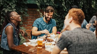 young adults at outdoor restaurant table Xdg.width .jpg