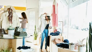 Woman trying on hat while boutique shopping w.width pnoSR.jpg