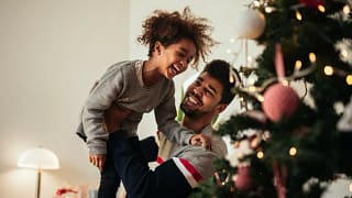 dad and daughter decorating christmas tree.width .jpg