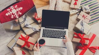 woman with laptop and holiday gifts.width .jpg