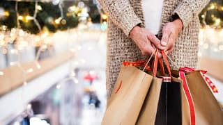 Woman holding shopping gift bags mPdZbn.width .jpg