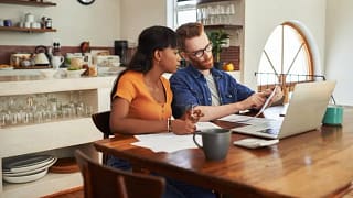 couple reviewing bills on laptop.width .jpg