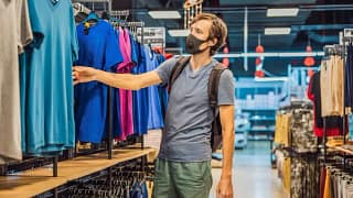 man wearing mask and shopping in clothing sto.width .jpg