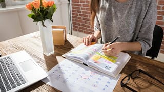 women at desk with calendar and planner.width .jpg