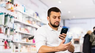 Customer in wheelchair scanning items to purc.width .jpg