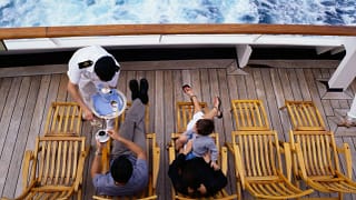 Server bringing family drinks as they lounge .width .jpg