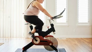 person on exercise bike at home kRawtlc.width .jpg