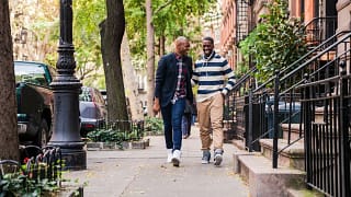 two men walking down street.width .jpg