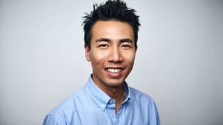 getty happy person in blue oxford shirt slight smiling.jpg