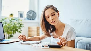 woman with calculator at home.width .jpg